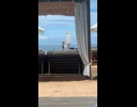 Collab IITW - Woman in white bikini and a bucket hat poses at the beach