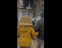 Woman wears upside down basket on head