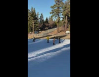 two girls in yellow bikinis and ear muffs ski