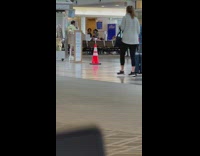 Woman grey leggings dance airport traffic cone