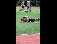 Man push-ups with dog on his back