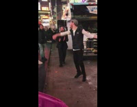 guys dancing in times square next to truck
