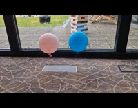 Pink and blue balloon float over air vent
