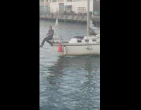 Guy sits at end of boat over water 
Part 2 