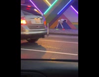 Man in white bunny costume poses on the sidewalk