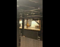 Man in yellow outfit does dance routine on pole