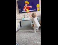 Baby dances to music video in home