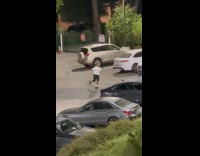 Man white shirt dance on parking lot