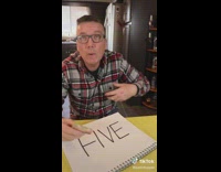 Man Crosses Out Letters F and E