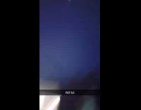 Fireworks explodes upwards and towards the man