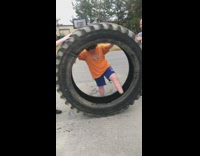 boy orange shirt giant tire