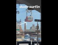 Black shirt guy stands red gondola lift 