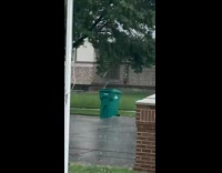 Green Garbage bin moved by low flood