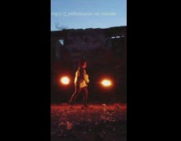 Woman fire dance spin pole with fire