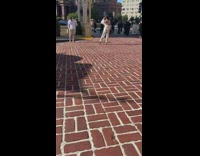 Girl white jacket hold bag brick pavement