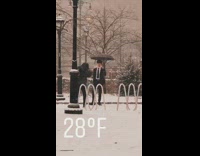 Guy poses in snow storm in suit 