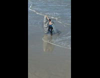 Collab Kook Of The Day - surfer walks with his  surfboard and silver surfboard cover 