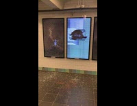 Broken smashed glass monitor display screens in subway station