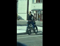 Woman rides bike shows off little crack