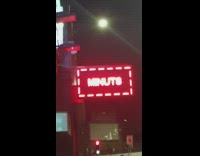 Guy laughs at phone repair LED sign 