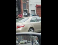 Guy aims leaf blower at posing lady