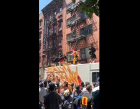 Ronald Mcdonald throws shirt at top truck