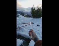 Person uses icicle as wand in snow