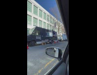 Guy rides tall unicycle 