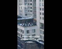 People on spin cycles outdoors on rooftop in cold weather