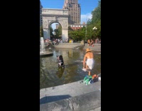 Man with towel wears underwear on fountain