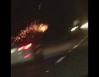 white car on highway with fire work held outside the car