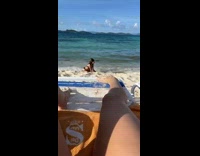 Two girls black bikini sit beach leg