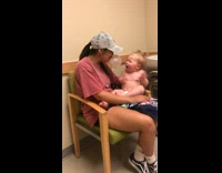 Baby screams when big sister blows a bubble gum bubble in her face