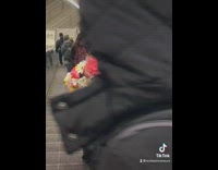 Woman wears flower covered coat 