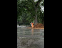 Man and woman wear bird mask at park