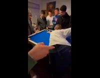 Guy do billiards shot then friends cheer
