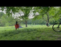 Guys joust in park wearing helmets