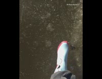 a man stands on ice and falls through
