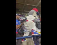 Man and shark mascot dance at baseball game