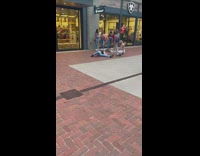 Friend lies on ground to take womans photo