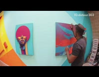 Guy plays music with paintings on wall