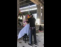 Guy cuts hair sidewalk mirror fence cape 