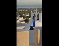 Woman in blue dress poses on the church roof Part 1