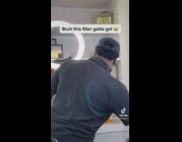 Guy applies lip filter on barber and other people in shop