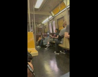 Guy uses laptop in armchair on train 