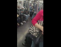 Shirtless guy wearing grey jacket dances by metal pole 