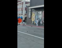 Man white outfit rap music video shoot graffiti wall