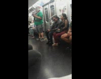 The Jolly Cat green elf shirt plays purple ukulele and sings on subway train