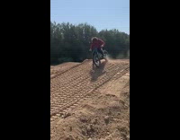 Guy jumps blue bicycle dirt adidas pants