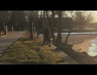 Guy poses in front of a tree